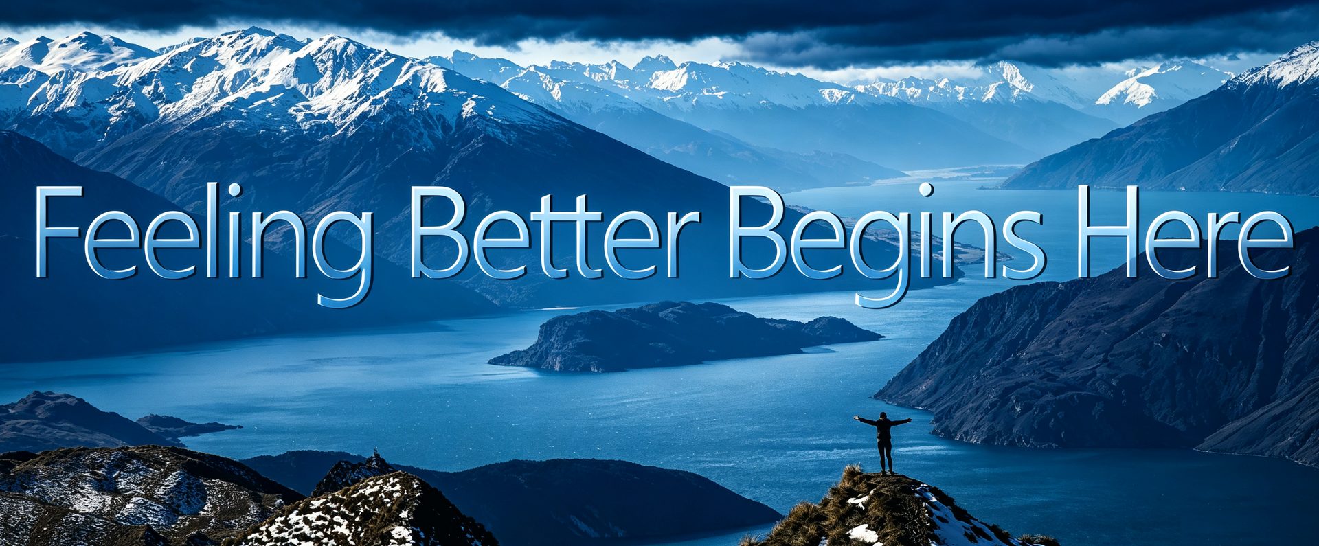 A person standing on a summit above a mountain lake, with the words “Feeling Better Begins Here.”